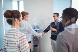 Young business colleagues shaking hands at office