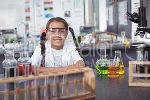 Portrait of elementary student wearing protective eyewear at laboratory