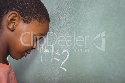 Student leaning on chalkboard