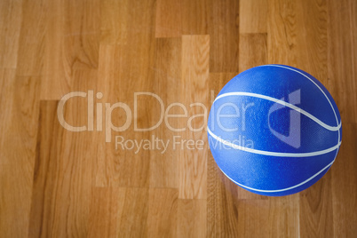 Overhead view of blue basketball on hardwood floor