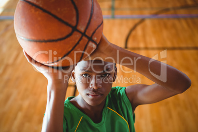 High angle view of teenage boy practicing basketball