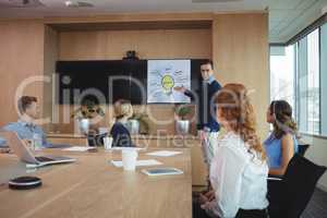 Businessman explaining plans to colleagues