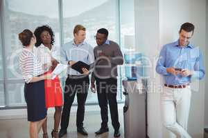 Business colleagues discussing by water cooler