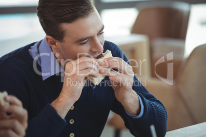 Businessman having breakfast at office cafeteria