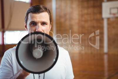 Portrait of male coach using megaphone