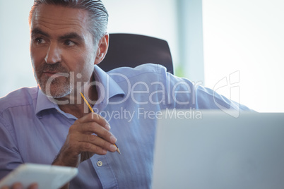 Concentrated businessman looking away