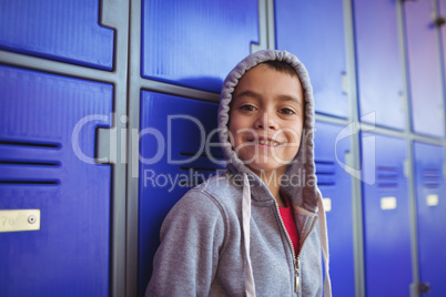 Portrait of smiling boy standing by lockers