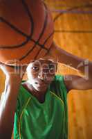 Portrait of teenage boy with basketball