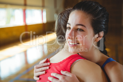 Close up of female basketball players embracing