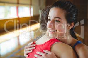 Close up of female basketball players embracing