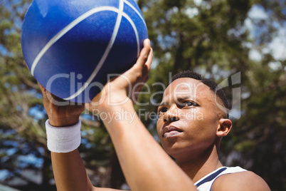 Close up of teenage boy practicing basketball