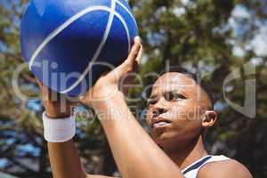 Close up of teenage boy practicing basketball