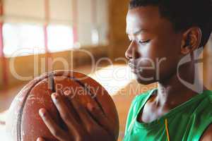 Teenage boy looking at basketball