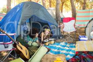 Couple talking while relaxing in tent