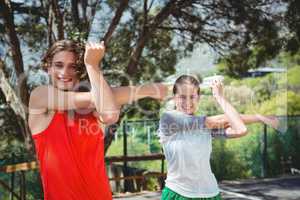 Portrait of friends exercising on road