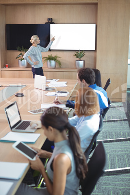 Colleagues at conference table during business meeting
