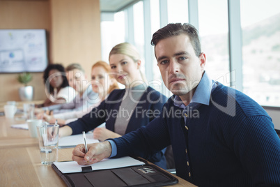 Portrait of business people sitting at office