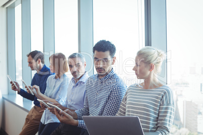 Business colleagues using technologies at office