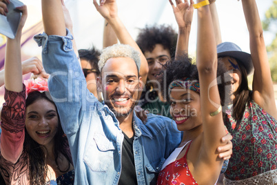 Portrait of happy friends enjoying during music festival