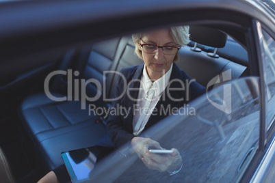 High angle view of businesswoman using phone in car