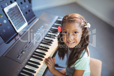 Portrait of elementary girl practicing piano