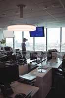 Businessman using virtual reality glasses by desk