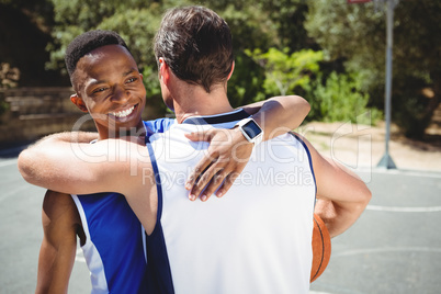 Happy basketball players embracing