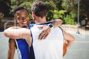 Happy basketball players embracing