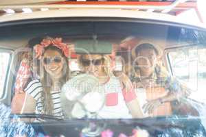 Portrait of happy friends in camper van seen through windshield
