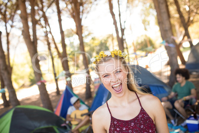 Portrait of cheerful young woman at campsite
