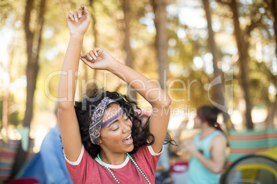 Happy woman dancing at campsite