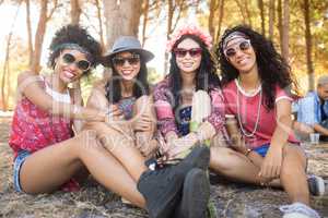 Portrait of happy female friends sitting together at campsite