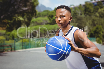 Male teenager holding basketball