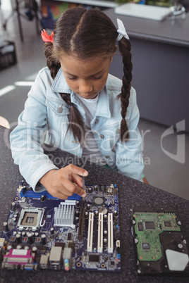 High angle view of elementary girl assembling circuit board