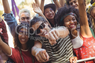Cheerful man with friends enjoying at music festival