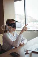 Businesswoman anticipating while using virtual reality technology at office