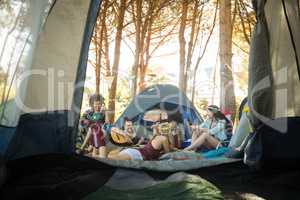 Happy young friends enjoying together at campsite