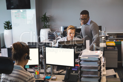 Focused young business colleagues working at office