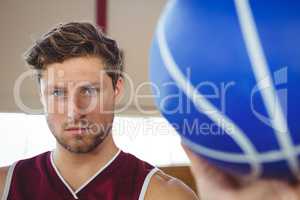 Close up portrait of serious basketball player holding ball