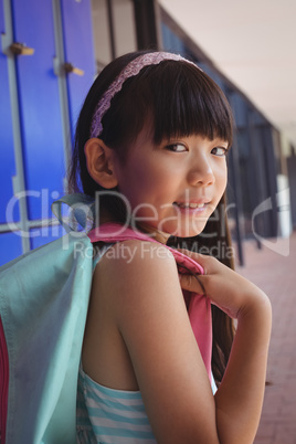 Portrait of girl with backpack in corridor