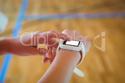 Cropped image of woman using smartwatch