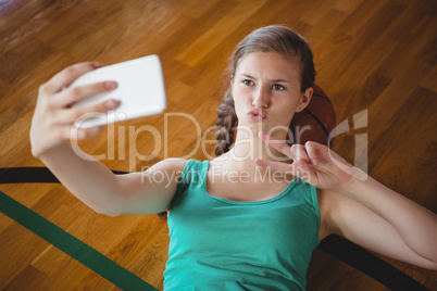 Basketball gesturing while player taking selfie