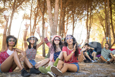 Cheerful friends enjoying together at campsite