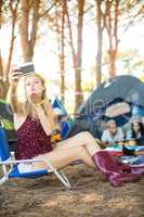 Young woman taking selfie at campsite