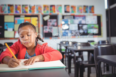 Girl studying while sitting at desk