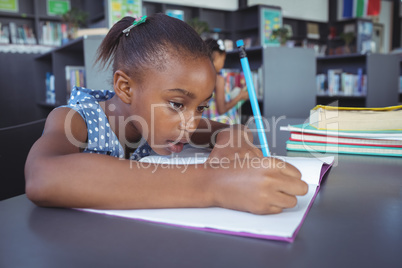 Girl studying at desk in library