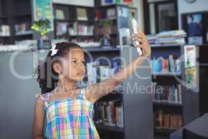 Girl taking selfie in library