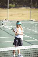 Girl playing tennis during sunny day