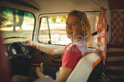 Portrait of man driving camper van