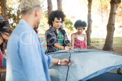 Young friends setting up tent